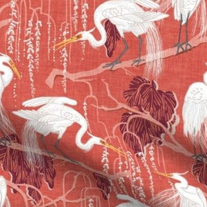 May include: A red fabric with a repeating pattern of white egrets standing in a stylized willow tree. The egrets are depicted in a white silhouette against a red background.