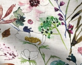May include: A watercolor floral print fabric featuring a variety of flowers and leaves in shades of pink, green, yellow, and brown on a white background.