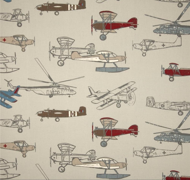 May include: A beige background with a pattern of various vintage airplanes in different colors, including red, brown, blue, and gray. The airplanes are drawn in a cartoon style and are flying in different directions.