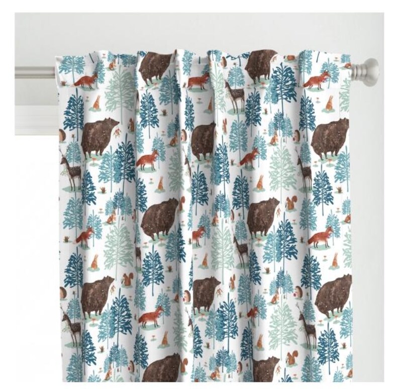 May include: White fabric with a repeating pattern of blue and green trees, brown bears, red foxes, and other woodland creatures.