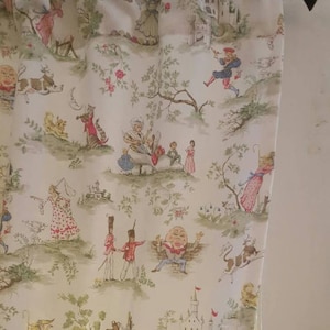 May include: White fabric with a whimsical pattern featuring a variety of characters and scenes. The characters include a man with a large head, a cat, a dog, and a woman in a dress. The scenes include a castle, a forest, and a garden.