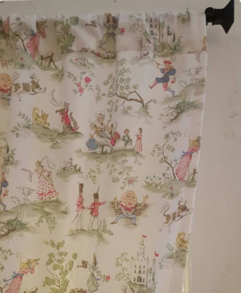 May include: White fabric with a whimsical pattern featuring a variety of characters and scenes. The characters include a man with a large head, a cat, a dog, and a woman in a dress. The scenes include a castle, a forest, and a garden.