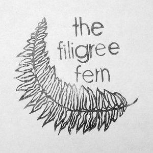 May include: Black and white illustration of a fern with the text "the filigree fern" above it.