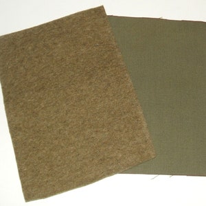 May include: Two rectangular fabric swatches. One is a textured, light brown felt. The other is a smooth, olive green canvas. Both are displayed against a white background. The felt swatch is slightly larger and overlaps the canvas.