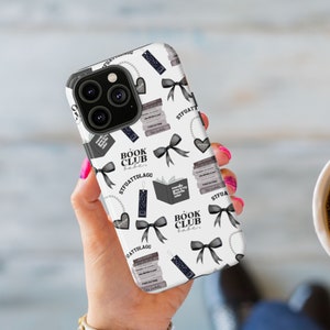 May include: White iPhone case with a black and gray pattern of books, bows, and the text "Book Club Babe".