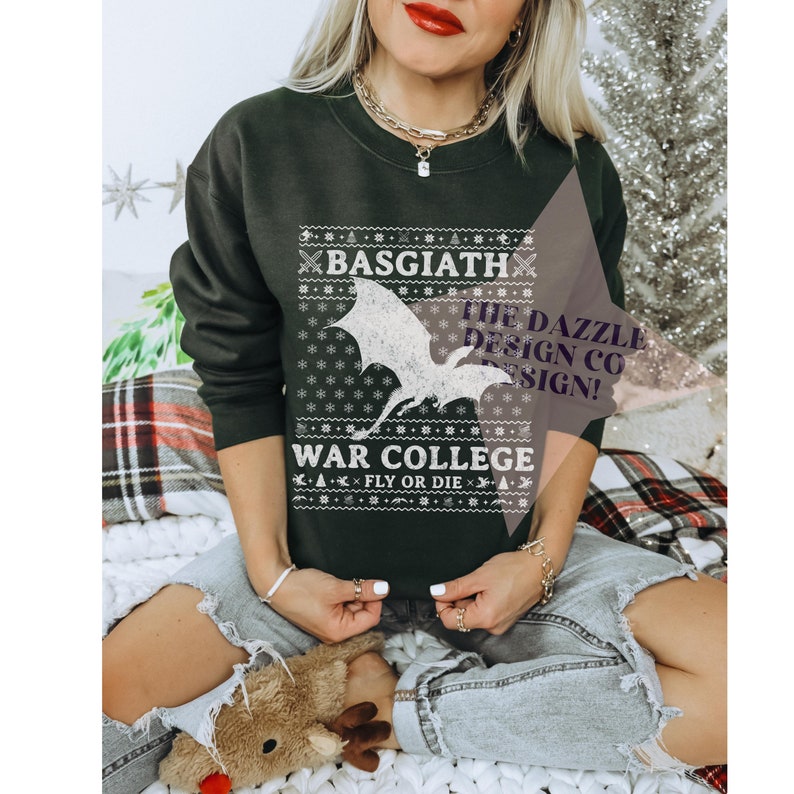Girl wearing jeans and a gray sweatshirt with white lettering that has a dragon and says 'Basgiath War college. Fly or Die.'
