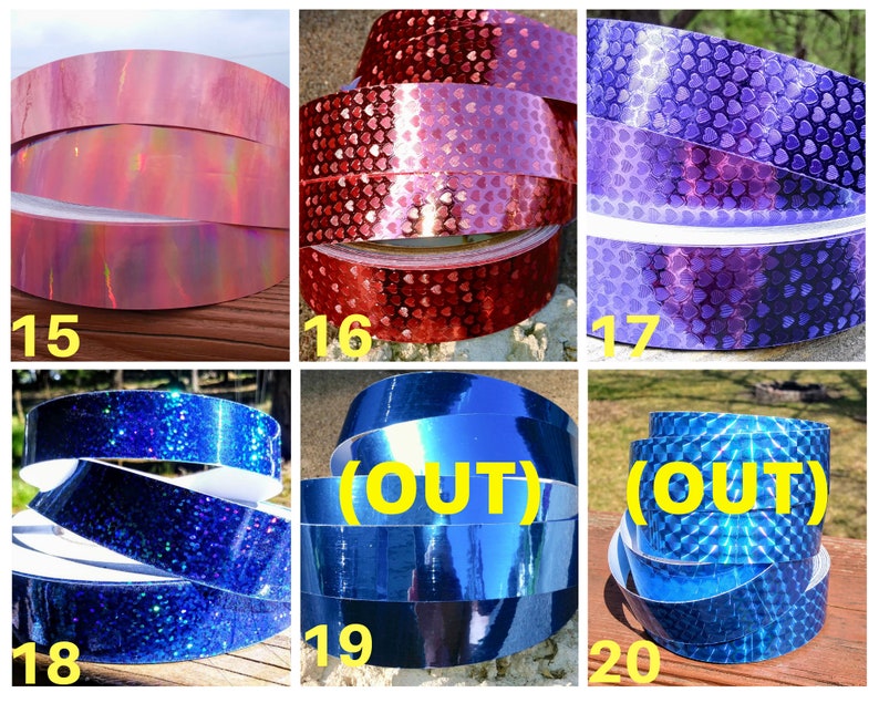 May include: A selection of decorative tapes in various colours and patterns. Includes pink iridescent, red heart-patterned, purple heart-patterned, blue glitter, solid blue, and blue diamond-patterned tapes. Each tape is labelled with a number.