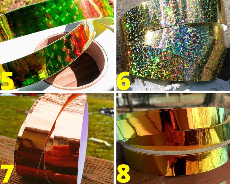 May include: Close-up of four rolls of decorative tape in various colours. The tape colours include green, gold, and copper. The tape is on a white roll. The tape is reflective and shiny.
