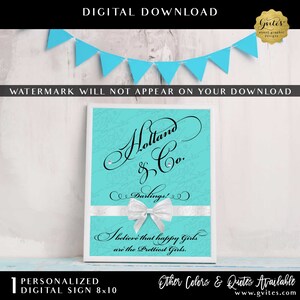 May include: A rectangular sign with a bright turquoise background featuring black cursive text that reads Holland & Co. Darlings! I believe that happy Girls are the Prettiest Girls. A white ribbon with a bow is centered across the lower portion.