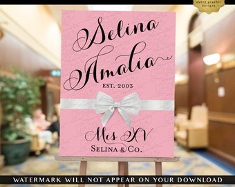May include: A pink rectangular digital sign featuring the black text Selina Amalia, EST. 2003, Mis XV, and SELINA & Co. A white ribbon with a bow is centered horizontally across the sign. The background has a repeating watermark pattern.