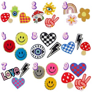 May include: A collection of embroidered patches with various designs. Includes a red mushroom, a yellow smiley face, a checkered heart, a peace sign, a rainbow, and an evil eye. The patches are in various colors and shapes, with some having glittery borders.
