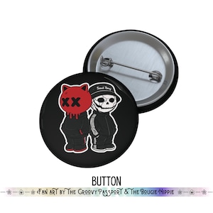 May include: Two black buttons with cartoon figures. One button features a red cat-like character with an "XX" face, and the other has a skull-like figure wearing a "Soul Boy" hat. The word "BUTTON" is at the bottom.