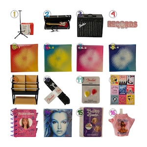 May include: A collection of sixteen miniature music-themed items including a guitar stand, a miniature red electric guitar in a case, a black Fender amplifier, a Records sign, four colorful vinyl record sleeves, a record rack, a guitar strap, Fender picks, a collage print, a Britney Spears notebook, a portrait print, a pin set, and a pink shirt.