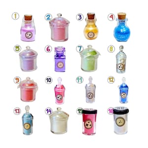 May include: A collection of sixteen miniature glass jars and bottles filled with various colored powders and liquids, each labeled with a circular sticker featuring a star icon and numbered one through sixteen in a white circle.