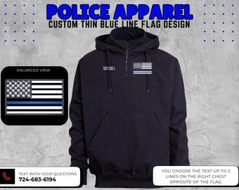 May include: Navy blue hooded sweatshirt with a thin blue line American flag patch. The text "POLICE APPAREL" and "CUSTOM THIN BLUE LINE FLAG DESIGN" are displayed at the top. The sweatshirt has a front pocket and a zipper at the neck.
