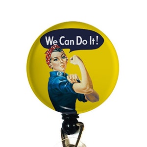 May include: A yellow and blue retractable badge holder with a round, printed image of a woman with her fist raised and the text "We Can Do It!"