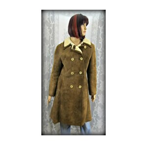 May include: A brown suede coat with a white faux fur collar and double breasted closure. The coat has a long, A-line silhouette.