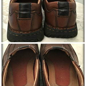 May include: A pair of brown leather slip-on shoes with a black rubber sole. The shoes have a brown leather lining and a brown leather insole.
