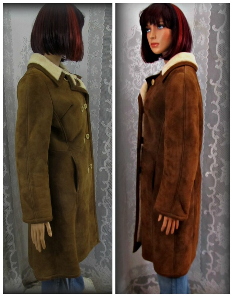 May include: A brown suede coat with a shearling collar and a double-breasted closure.