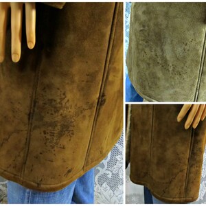 May include: A brown suede coat with a long length and a collar. The coat has a few stains on the front.
