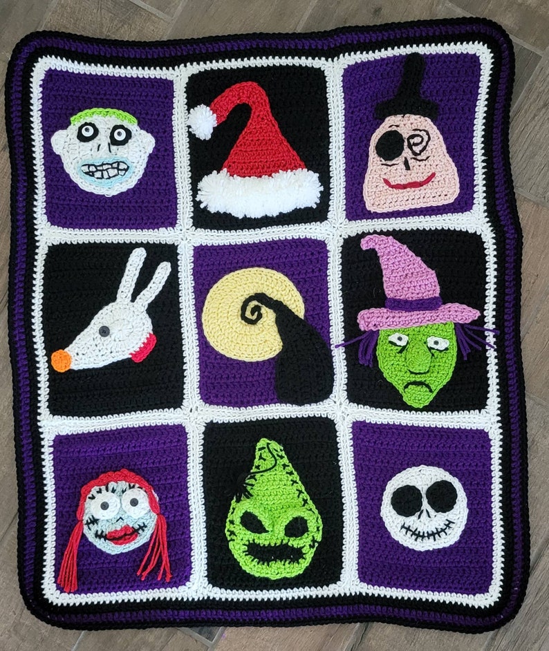 May include: A crocheted blanket featuring characters from the Nightmare Before Christmas. The blanket is purple, black, and white with squares featuring Jack Skellington, Sally, Oogie Boogie, Zero, and other characters.