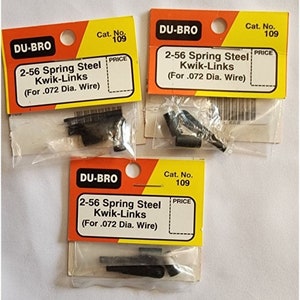 May include: Three packages of black 2-56 spring steel Kwik-Links for .072 diameter wire. Each package has a yellow and orange label with the text "DU-BRO" and "Cat. No. 109".