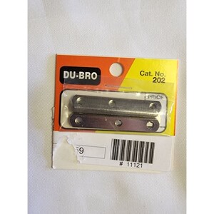 May include: A pack of two silver metal brackets, each with three holes. The packaging is labelled "DU-BRO" and "Cat. No. 202".