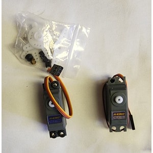 May include: Two gray H-King servo motors with orange and yellow wires, a white plastic gear, and a bag of white plastic parts.