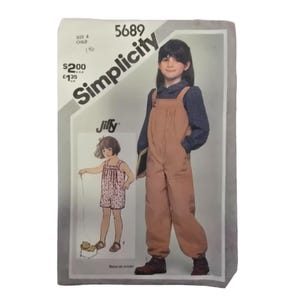 May include: Simplicity sewing pattern number 5689 for a child's Jiffy overalls. The pattern includes instructions for making a pair of brown overalls with pockets and a matching top. The pattern is for sizes 6-child.