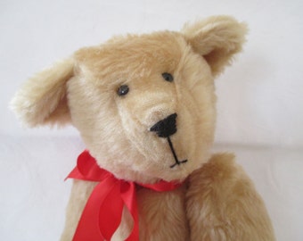 THEO; A camel colored plush teddy bear sure to bring a smile.