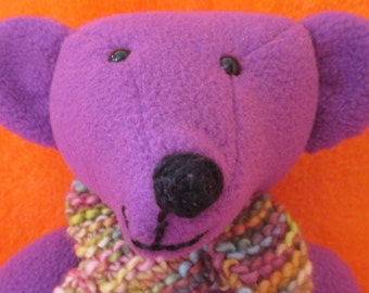 HEATHER: A funky fleece Fiesta bear,soft and plummy purple.