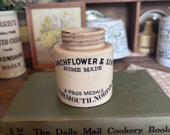 May include: A vintage ceramic jar with a brown glaze and black lettering. The jar reads "ANCHFLOWER & SON HOME MADE 4 PRIZE MEDALS YARMOUTH, NORFOLK".