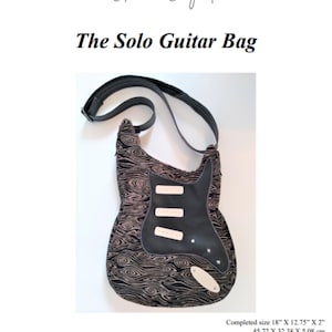 Puede incluir: Una bolsa de guitarra negra y blanca con una correa. La bolsa mide 45,72 cm por 32,38 cm por 5,08 cm. La bolsa está diseñada para un nivel de habilidad intermedio.