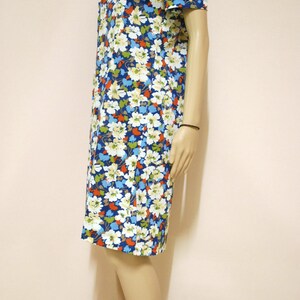May include: A blue floral print dress with short sleeves and a knee-length hem.