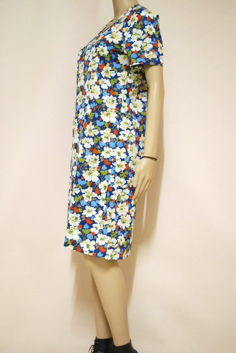 May include: A blue floral print dress with short sleeves and a knee-length hem.