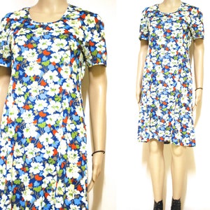 May include: A short-sleeved dress with a blue background and a white, red and green floral pattern.