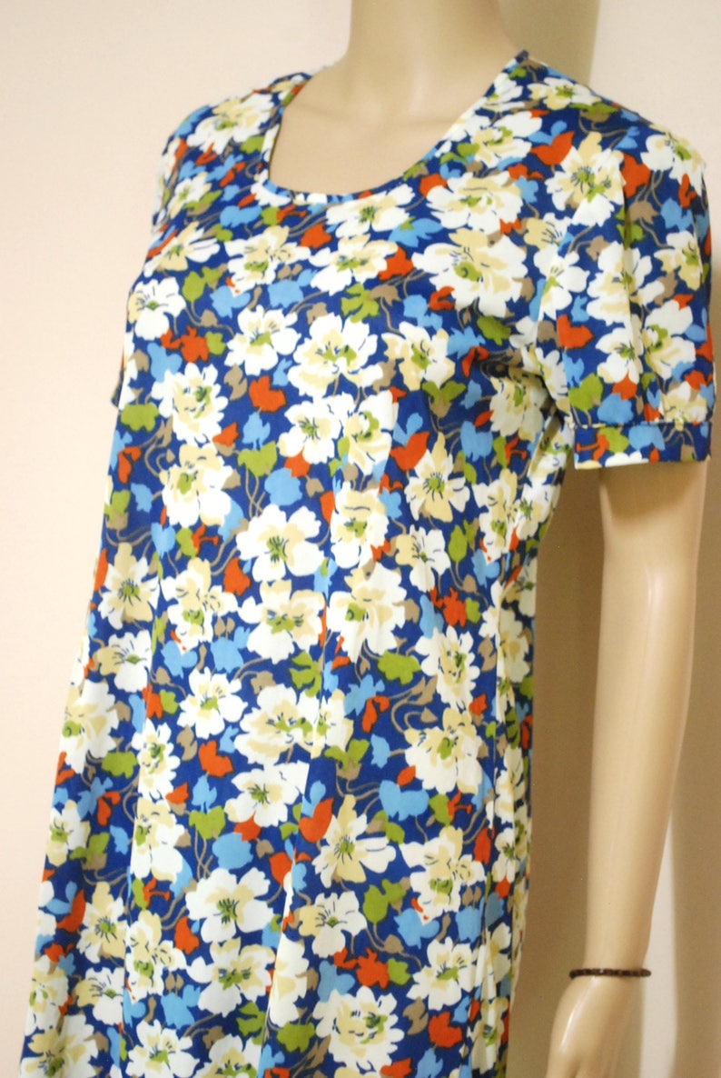 May include: A blue and white floral print short-sleeved dress with a scoop neck.