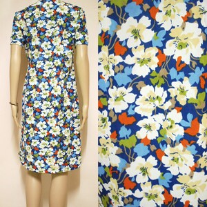 May include: A blue and white floral print dress with short sleeves. The dress has a fitted bodice and a slightly flared skirt.
