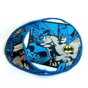 May include: Two blue fabric patches with a comic book style image of Batman in a blue and gray costume. The text "SHHH!" is visible on the patch.