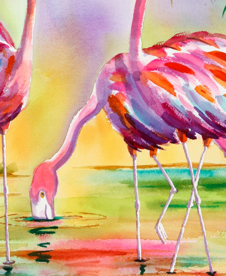 Op de afbeelding: Twee roze flamingo's met lange poten staan in een ondiep waterlichaam. De flamingo links drinkt uit het water, terwijl de flamingo rechts zijn kop omhoog heeft. Het water is lichtblauw en de achtergrond is een zachte aquarelverloop in roze, geel en groen.