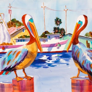 May include: Two brown and blue pelicans with orange beaks stand on wooden posts in a harbor. The pelicans are facing different directions. The water is blue and there are boats in the background.