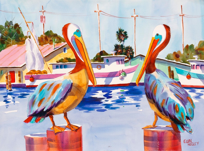 May include: Two brown and blue pelicans with orange beaks stand on wooden posts in a harbor. The pelicans are facing different directions. The water is blue and there are boats in the background.