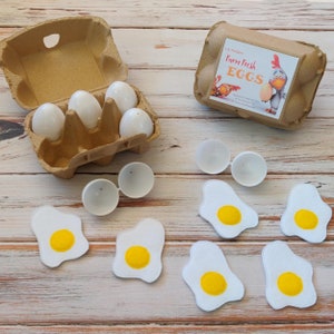 Play food felt eggs in crack able plastic egg shells. Set of 6 comes with real cardboard carton, and a fun label on top. Optional bacon slices also available.