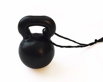 May include: A black kettlebell ornament with a black string attached.
