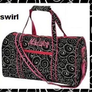 May include: Black and pink travel duffel bag with a swirl pattern and the word "Maddie" embroidered on the front.