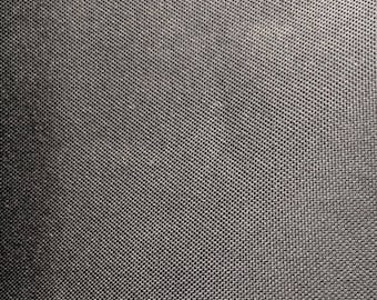 May include: Close-up of a black fabric with a textured woven pattern.