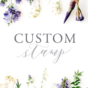 May include: White background with the words "CUSTOM Stamp" in gray lettering. The image is framed with an assortment of flowers and greenery, including purple, white, and green elements, creating a decorative border.