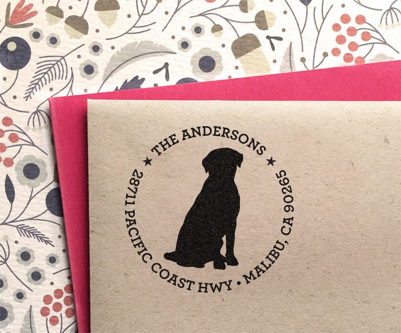 May include: A brown paper return address label with a black silhouette of a dog sitting. The text reads "The Andersons", "28711 Pacific Coast Hwy", "Malibu, CA 90265".