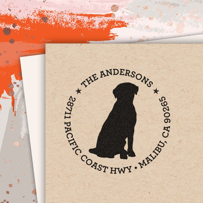 May include: A black and white return address stamp with a silhouette of a dog sitting. The text reads "The Andersons", "28711 Pacific Coast Hwy", "Malibu, CA 90265".