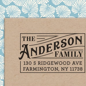 May include: A brown paper envelope with a black and white printed label. The label reads "The Anderson Family", "130 S Ridgewood Ave", and "Farmington, NY 11738".